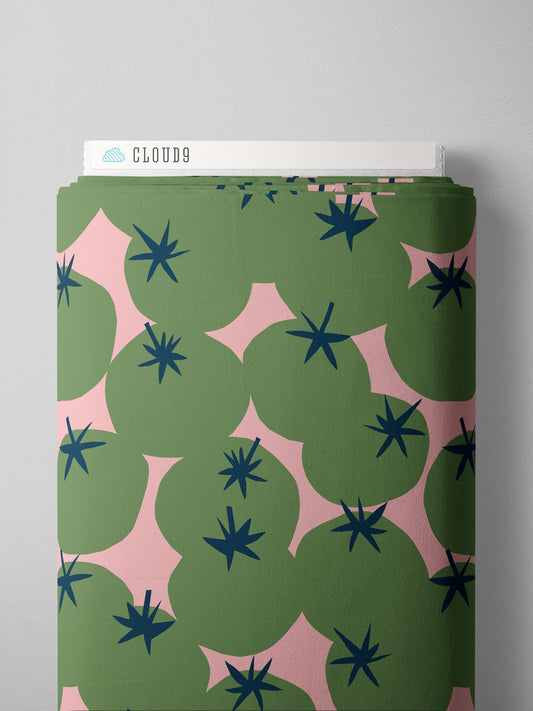 green tomatoes on a light pink background