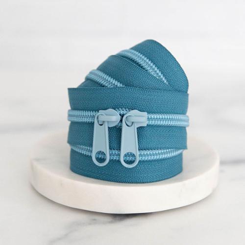 30" zipper Blueprint, Blue zipper on a white marble surface