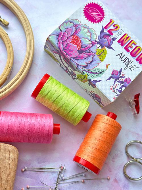 tula pink aurifil 12wt thread set in neon pink, neon yellow and neon orange