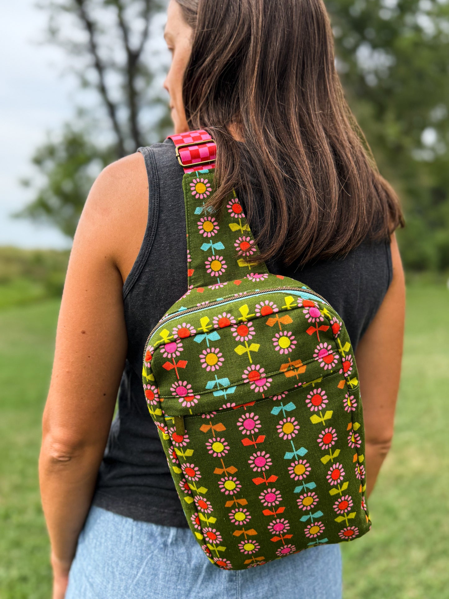 Person wearing a green floral-patterned backpack outdoors