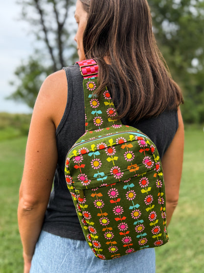 Person wearing a green floral-patterned backpack outdoors