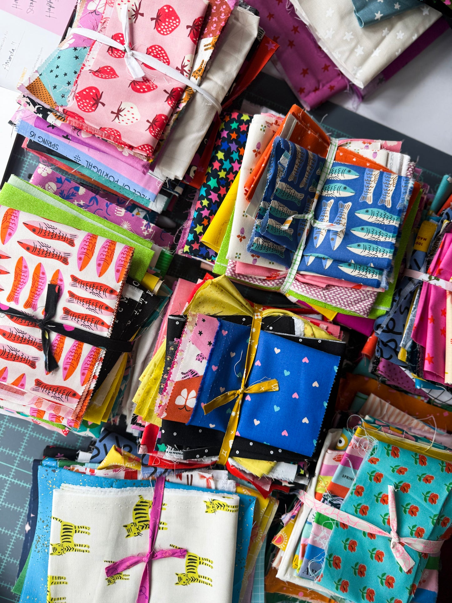 Collection of colorful fabric scraps with various patterns bundled together