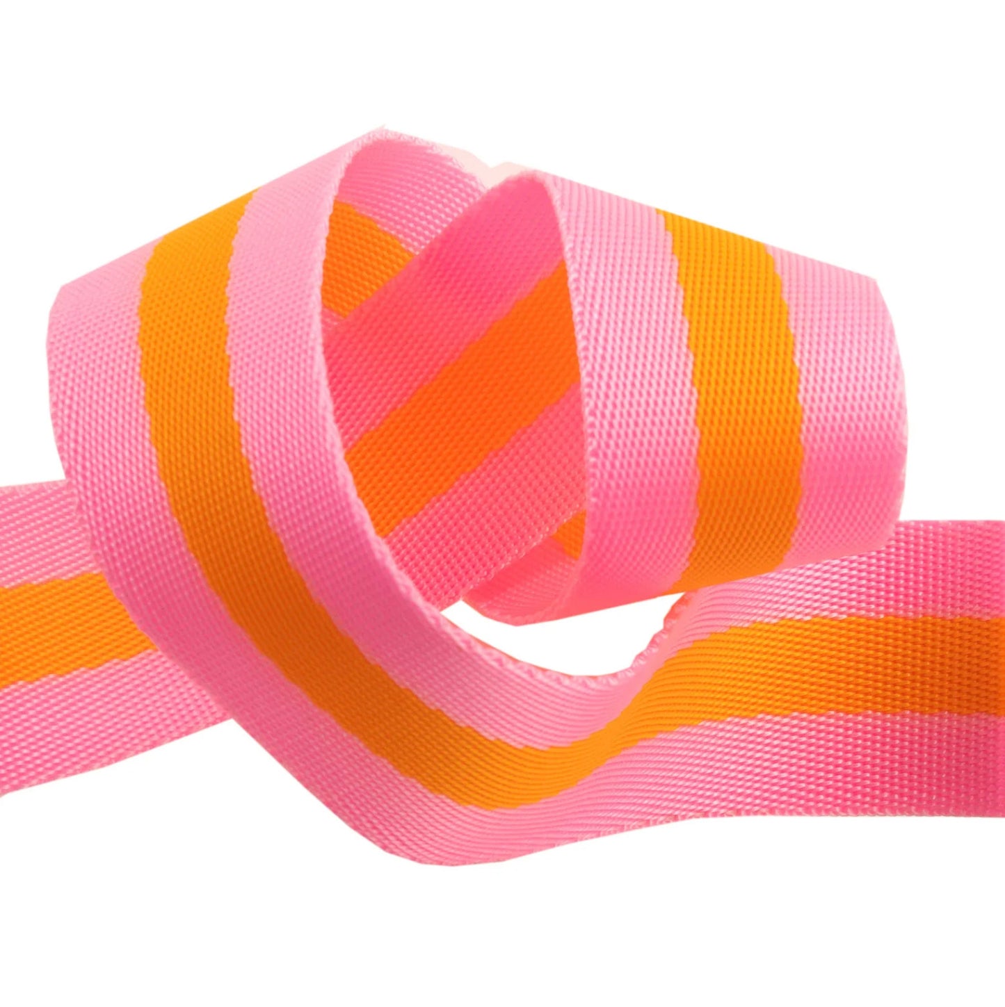 close up of tula pink 1.5" nylon webbing, in pink + orange colorway