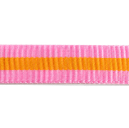 detailed close up of tula pink 1.5" nylon webbing, in pink + orange colorway